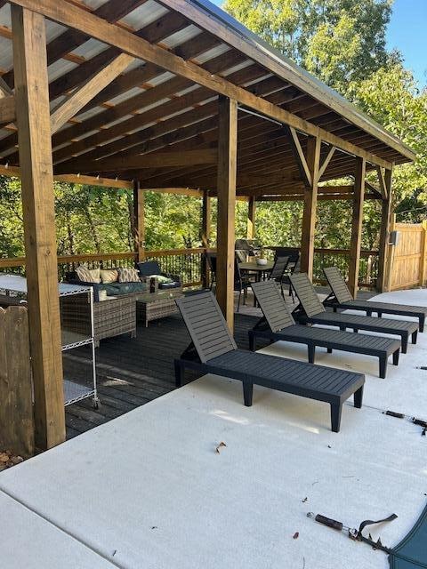 view of home's community featuring a wooden deck and an outdoor living space