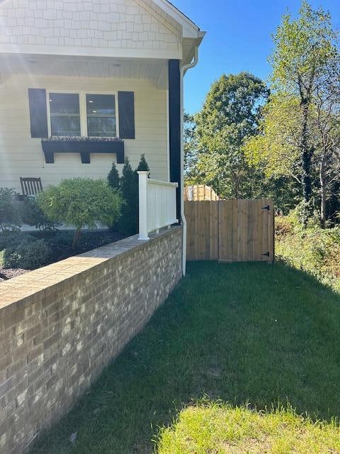 view of side of property with a yard