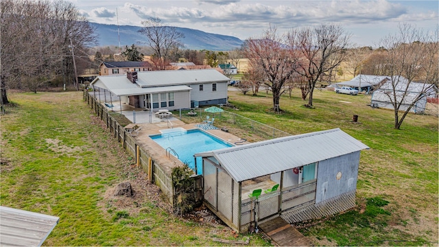 exterior space featuring a fenced in pool, a patio, a lawn, a mountain view, and fence private yard