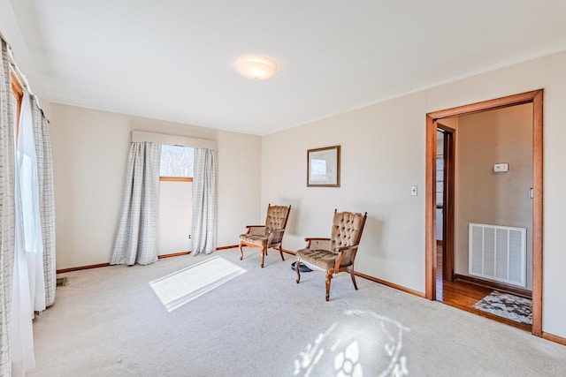 sitting room with carpet, visible vents, and baseboards