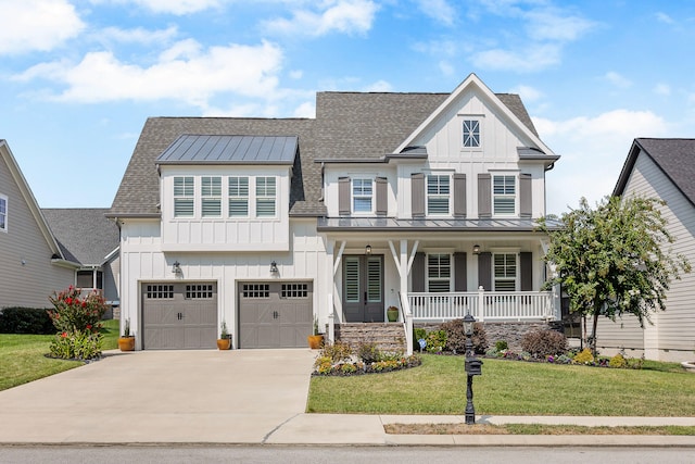 view of front facade with a front yard, a porch, and a garage