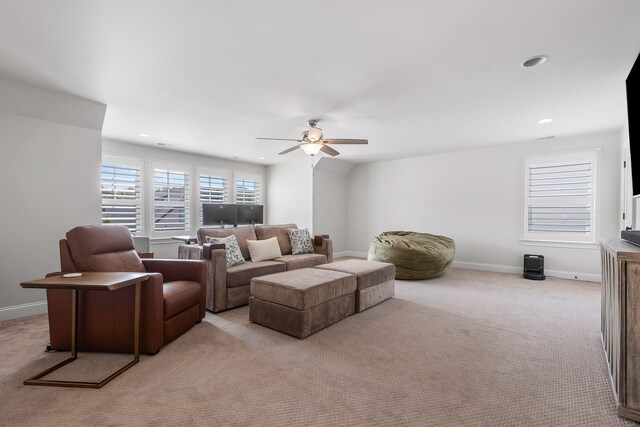 carpeted living room featuring ceiling fan