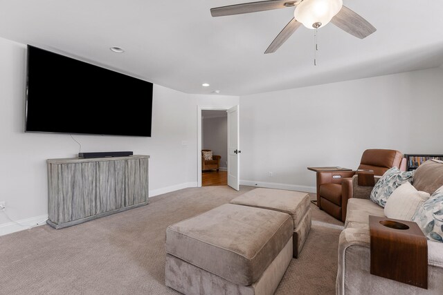 living room with ceiling fan and light colored carpet