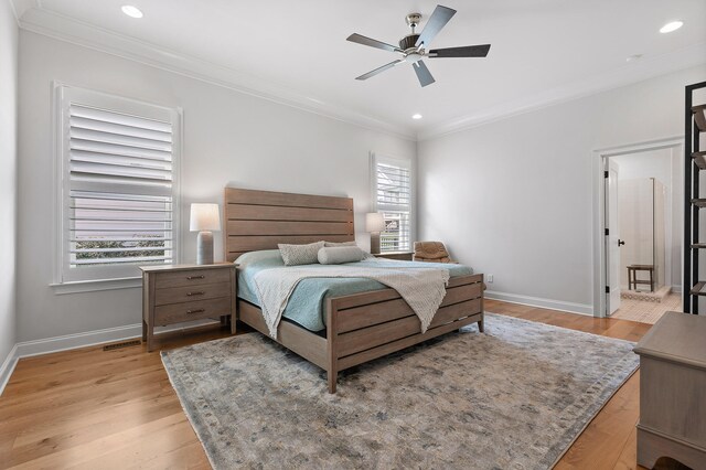 bedroom featuring ceiling fan, ornamental molding, and light wood-type flooring