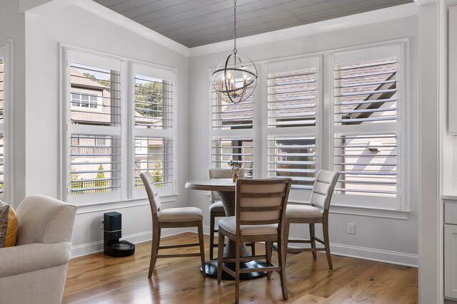 dining room featuring a notable chandelier, wood-type flooring, and crown molding