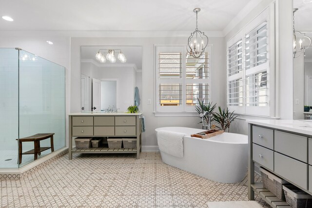 bathroom featuring a healthy amount of sunlight, crown molding, independent shower and bath, and an inviting chandelier