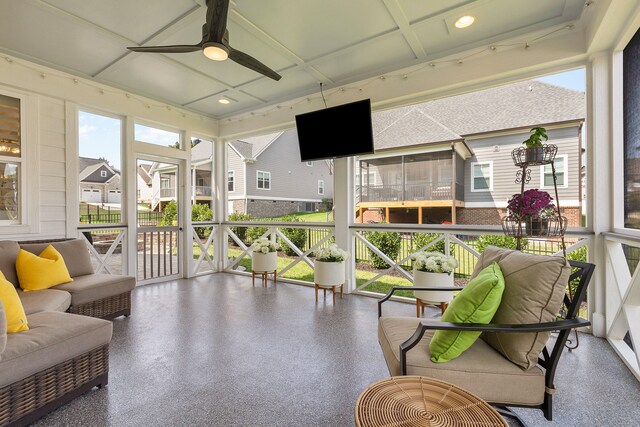 sunroom / solarium featuring ceiling fan and a wealth of natural light