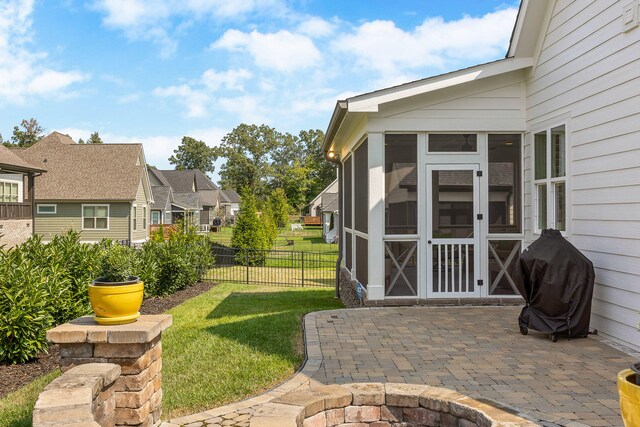 exterior space with grilling area and a sunroom