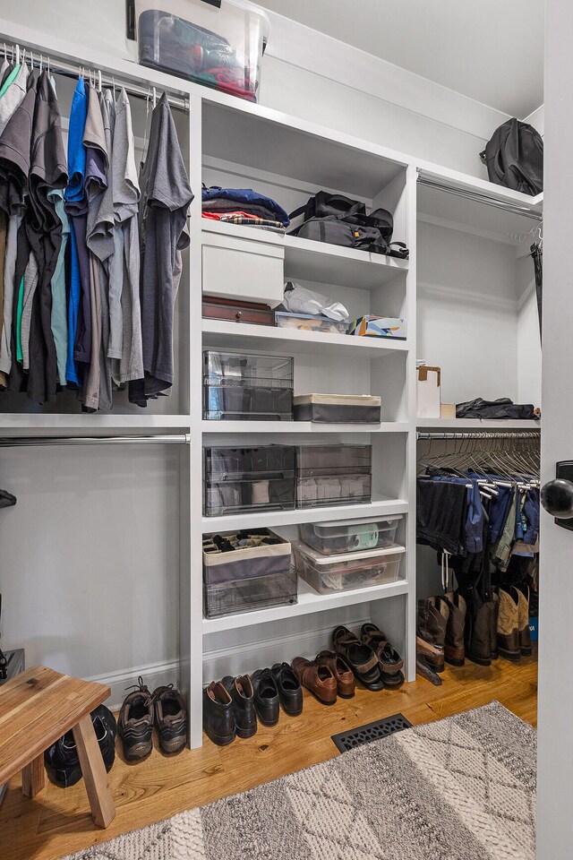 walk in closet with light wood-type flooring