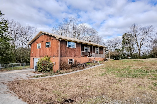 view of property exterior with a lawn, a porch, and a garage