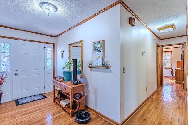 foyer entrance with ornamental molding, light hardwood / wood-style flooring, and plenty of natural light