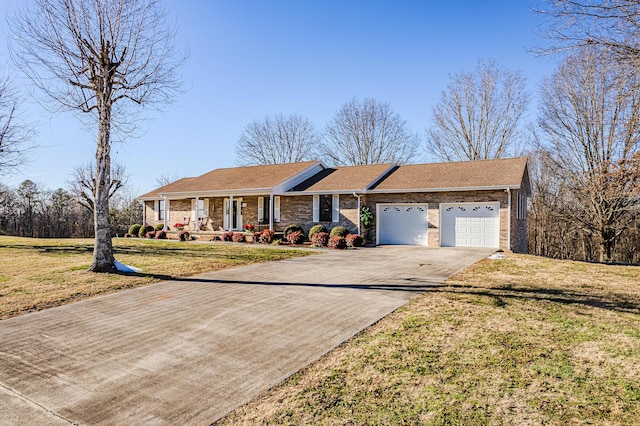 single story home with covered porch, a front lawn, and a garage