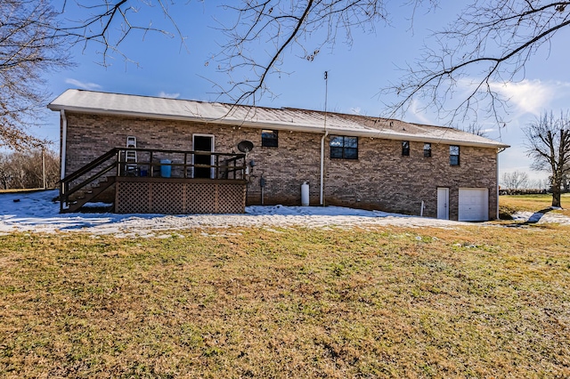 rear view of property with a garage and a yard