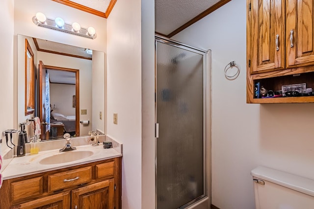 bathroom with ornamental molding, vanity, a textured ceiling, and a shower with shower door