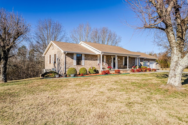 ranch-style home with a porch, a front yard, and a garage