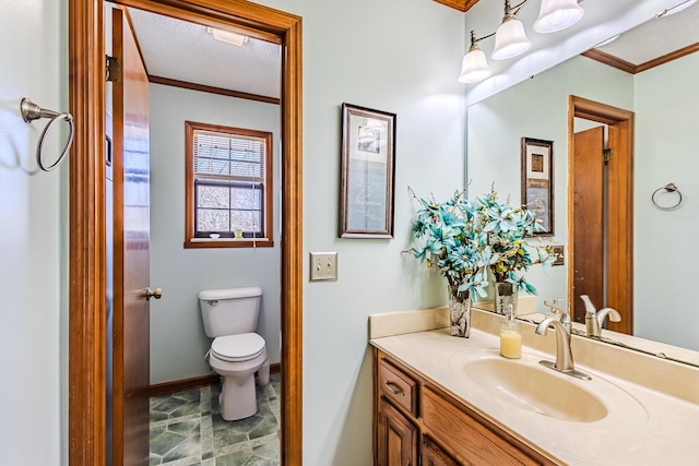 bathroom featuring toilet, crown molding, and vanity