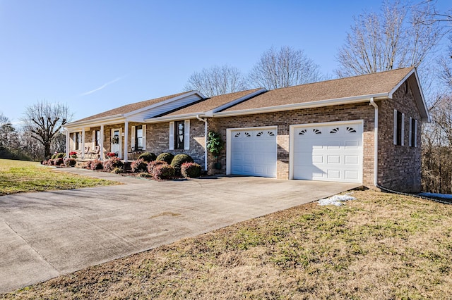 single story home with covered porch, a front lawn, and a garage