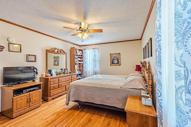 bedroom featuring ceiling fan, light hardwood / wood-style flooring, ornamental molding, and a textured ceiling