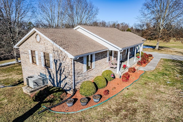 view of property exterior featuring ac unit, a porch, and a lawn