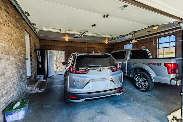 garage featuring a garage door opener and wooden walls