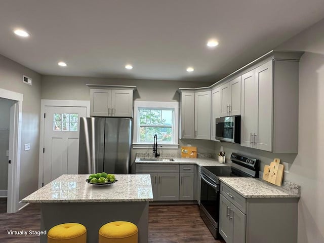 1344 Unity Dr NE, Cleveland, TN 37312 - kitchen featuring appliances with stainless steel finishes, plenty of natural light, gray cabinets, dark wood-style floors, and recessed lighting