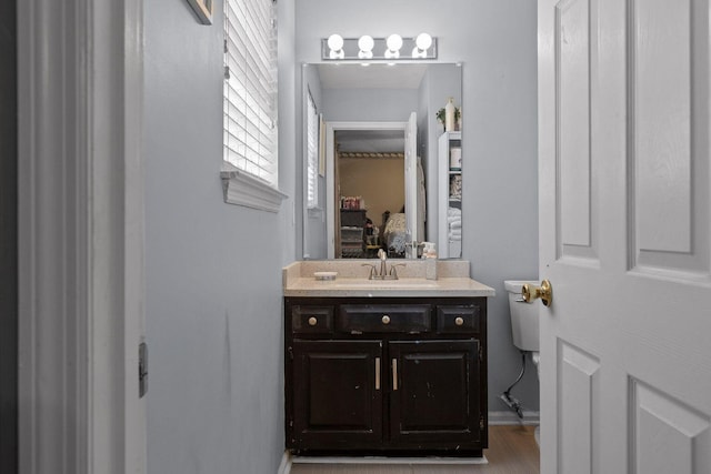 bathroom featuring vanity and toilet