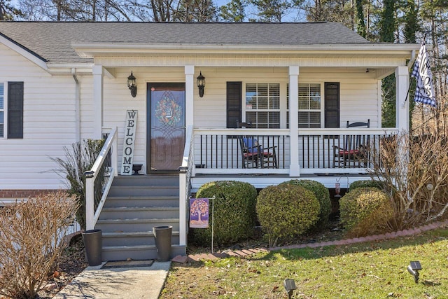 view of front of home featuring a shingled roof and a porch