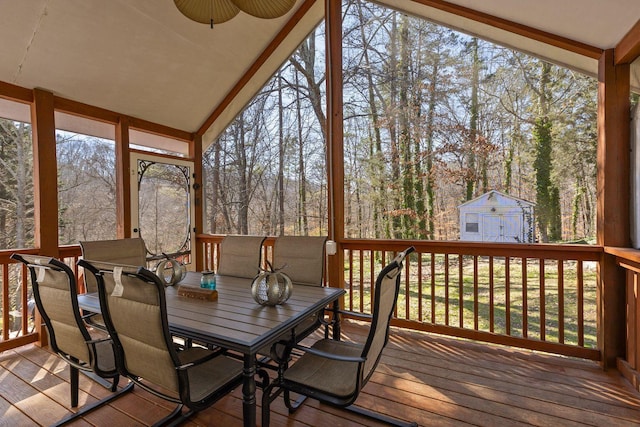 sunroom / solarium featuring vaulted ceiling