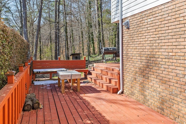 wooden deck featuring area for grilling