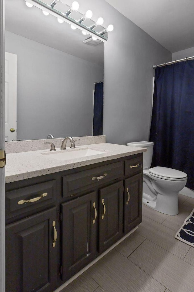 full bath featuring toilet and vanity