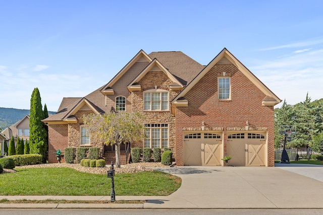 craftsman house featuring a garage and a front lawn