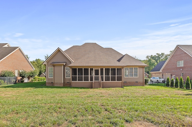 rear view of property featuring a lawn and a sunroom