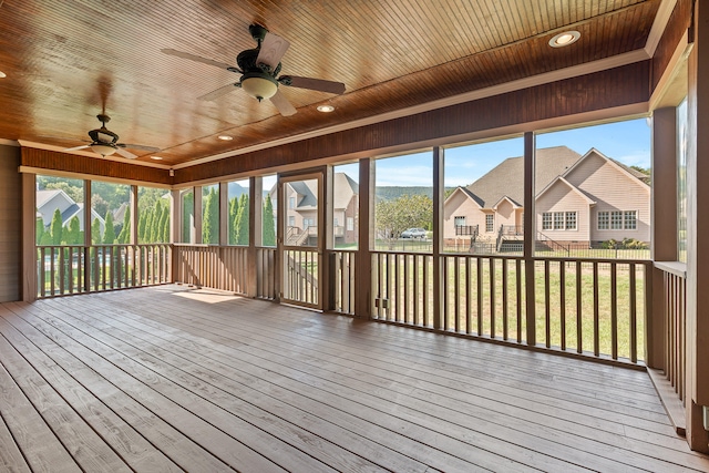 unfurnished sunroom featuring ceiling fan and wooden ceiling