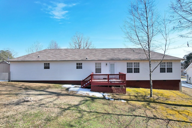 back of property with a yard and a wooden deck