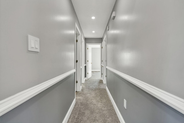 hallway with dark carpet