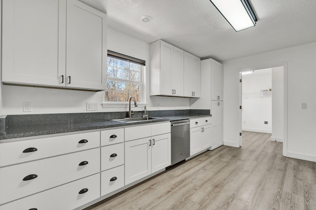 kitchen featuring sink, white cabinets, a textured ceiling, dishwasher, and light hardwood / wood-style floors