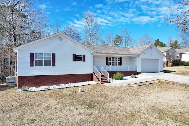 view of front of home with central AC, a garage, and a front yard