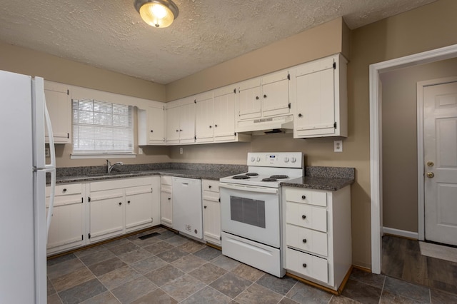 kitchen with white appliances, sink, a textured ceiling, and white cabinets