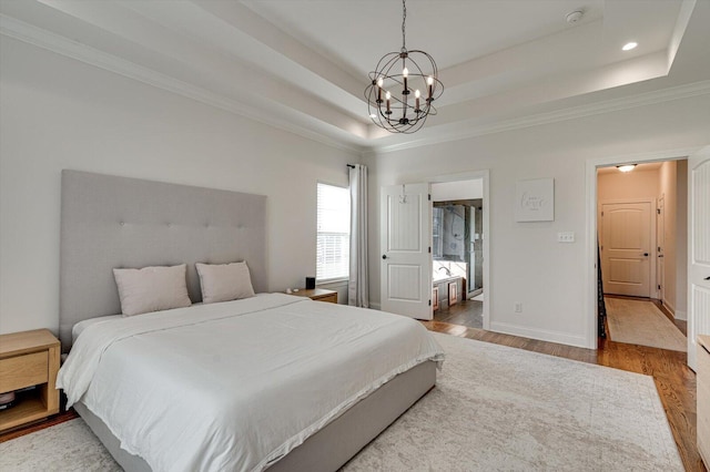 2074 Volunteer Dr SW, Cleveland, TN 37311 - bedroom featuring wood finished floors, baseboards, an inviting chandelier, ornamental molding, and a tray ceiling