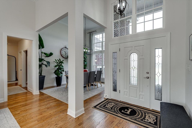 2074 Volunteer Dr SW, Cleveland, TN 37311 - foyer entrance with a notable chandelier, light wood-type flooring, and a towering ceiling