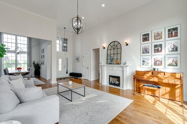 2074 Volunteer Dr SW, Cleveland, TN 37311 - living room with crown molding, a high ceiling, an inviting chandelier, and a healthy amount of sunlight