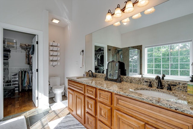 2074 Volunteer Dr SW, Cleveland, TN 37311 - bathroom featuring double vanity, toilet, a tile shower, and a sink
