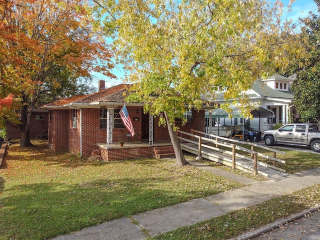 view of property hidden behind natural elements featuring a front yard