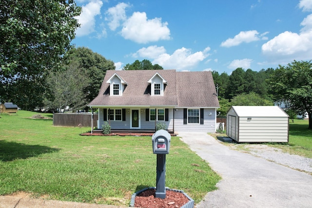 cape cod-style house with an outbuilding and a front lawn