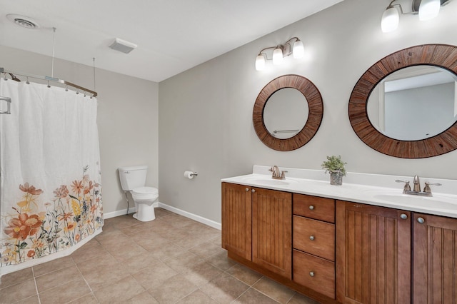 bathroom featuring tile patterned flooring, vanity, and toilet