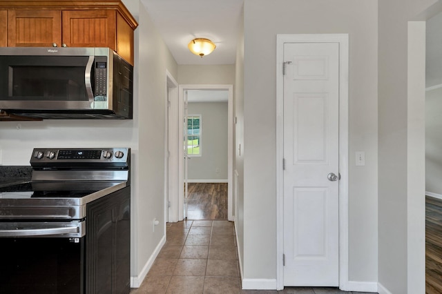 kitchen with light tile patterned floors and appliances with stainless steel finishes