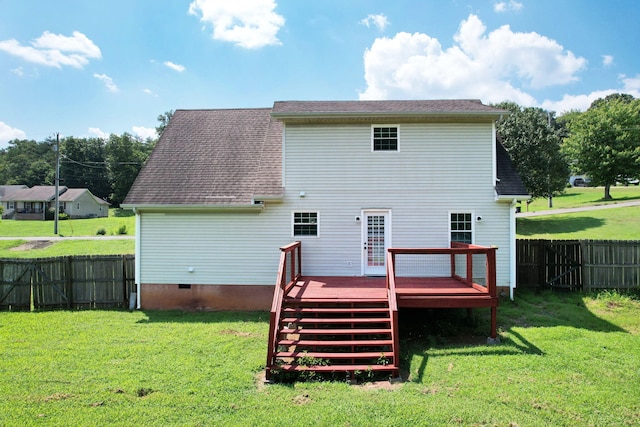 rear view of property with a yard and a deck