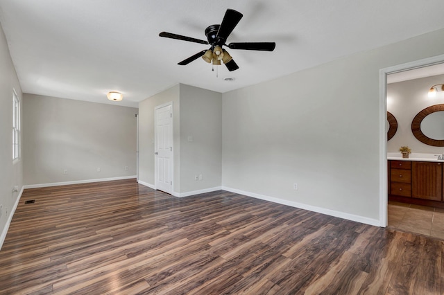 unfurnished room with dark hardwood / wood-style floors and ceiling fan