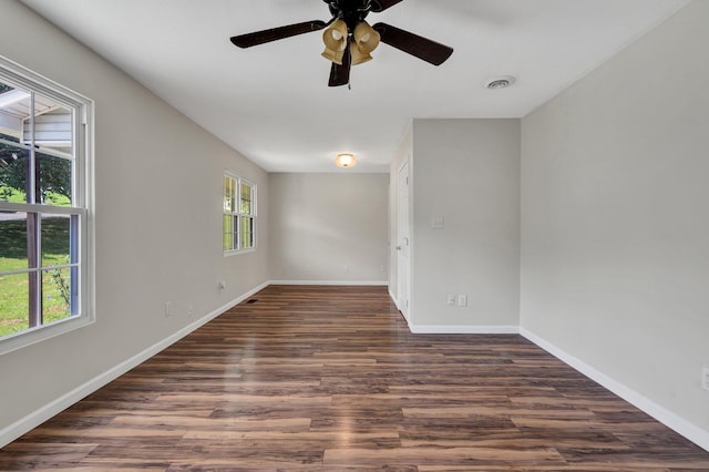 unfurnished room with plenty of natural light, dark hardwood / wood-style floors, and ceiling fan