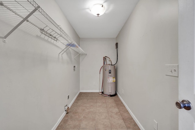 walk in closet with electric water heater and light tile patterned floors